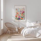 a bedroom with a bed, a woven chair, and a framed poster of a flower market in Woodbury.
