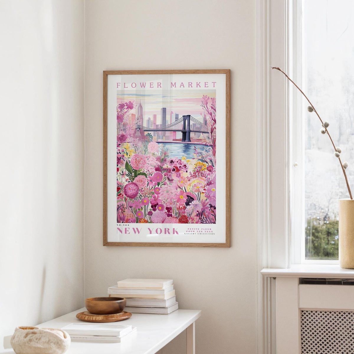a framed poster of a flower market in New York, with a bridge and colorful flowers in the background.