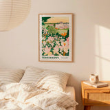 a bedroom scene with a framed poster of a garden hanging on the wall above a bed with striped pillows.