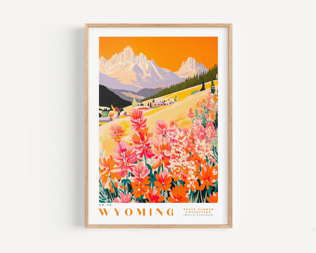The image is a framed poster depicting a scenic landscape with mountains, a valley, and a field of colorful wildflowers.