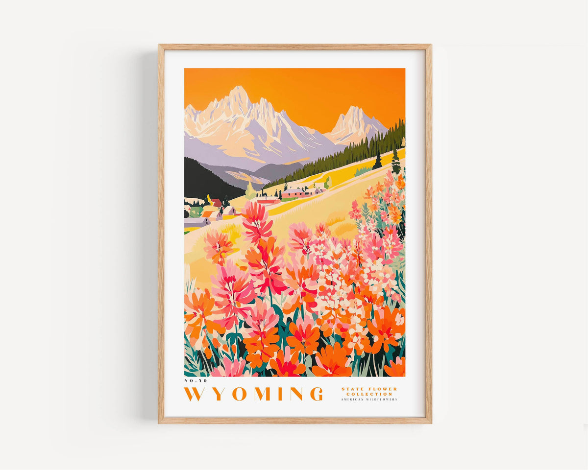 The image is a framed poster depicting a scenic landscape with mountains, a valley, and a field of colorful wildflowers.