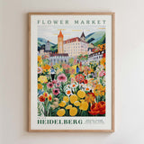The image is a framed poster depicting a vibrant and colorful flower market in Heidelberg, Germany.