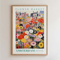 The image is a framed poster depicting a vibrant and colorful flower market in Amsterdam.