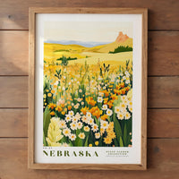 The image is a framed poster depicting a vibrant field of flowers, with a mountainous landscape in the background.