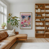 a cozy living room with a large window, a comfortable leather sofa, a wooden bookshelf filled with books, and a framed poster of a colorful floral landscape hanging on the wall.