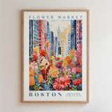 The image is a framed poster depicting a vibrant and colorful flower market in Boston, with tall buildings and a variety of flowers in the foreground.