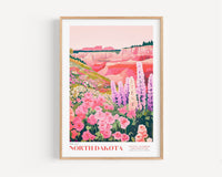 A framed illustration depicting a vibrant landscape with a variety of colorful flowers, including pink, purple, and white blooms, set against a backdrop of mountains and a clear sky.