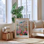 a living room with a large window, a framed poster of a colorful floral scene, a stack of books, a white sofa, and a potted plant.