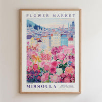 A framed poster depicting a colorful and vibrant flower market in Missoula, Montana.