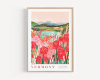 The image is a framed poster depicting a scenic landscape with mountains, a river, and a field of colorful flowers.