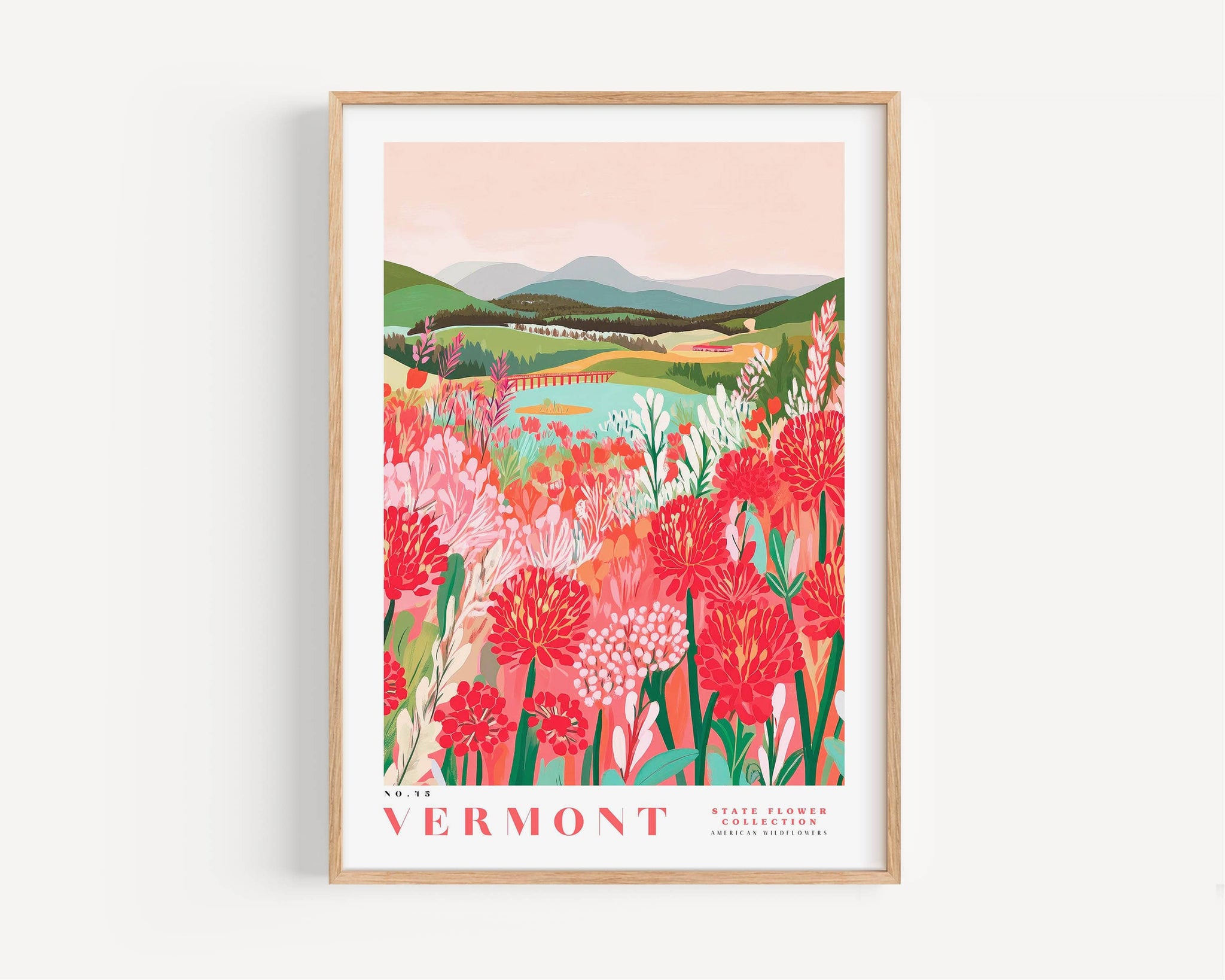 The image is a framed poster depicting a scenic landscape with mountains, a river, and a field of colorful flowers.