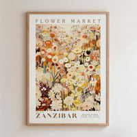 The image is a framed poster depicting a vibrant and colorful flower market in Zanzibar, featuring a variety of flowers and plants in different shades of orange, yellow, and white.