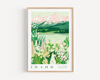 A framed illustration depicting a scenic landscape with mountains, a lake, and a field of wildflowers.