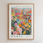 The image is a framed poster depicting a vibrant and colorful floral scene, with various flowers and plants in different shades of pink, orange, yellow, and green.