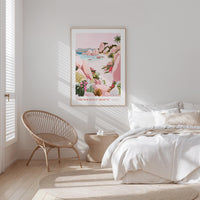 A bedroom with a large bed, a woven chair, and a framed poster of a tropical landscape hanging on the wall.