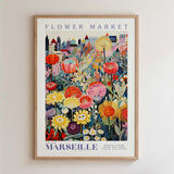 The image is a framed poster depicting a vibrant and colorful flower market in the city of Marseille, France.
