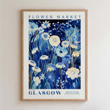 The image is a framed poster of a floral design with blue and white colors, depicting various flowers and plants.