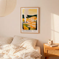 a bedroom scene with a framed poster of a scenic landscape hanging on the wall above a bed with striped bedding.