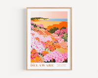 A framed illustration of a vibrant, colorful garden filled with various flowers and plants, set against a scenic coastal landscape.