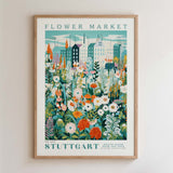 The image is a framed poster depicting a vibrant and colorful flower market scene with various flowers and plants.