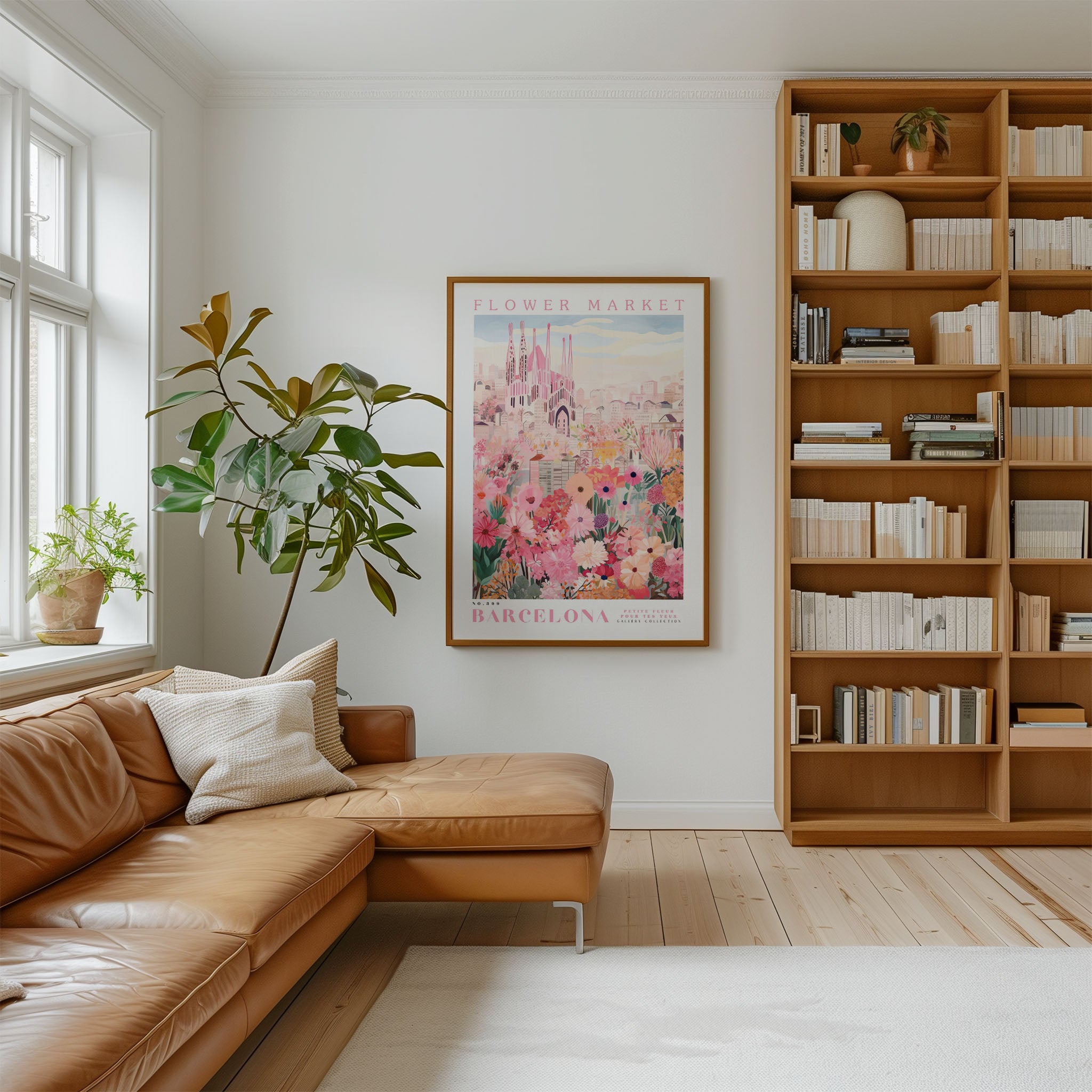 a cozy living room with a large window, a comfortable leather sofa, a wooden bookshelf filled with books, and a framed poster of a cityscape hanging on the wall.
