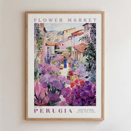 The image is a framed poster depicting a vibrant flower market in Perugia, Italy. The poster showcases a variety of colorful flowers and plants, with a person walking through the market. The text on the poster reads "FLOWER MARKET" and "PERUGIA", indicating the location and the name of the market.
