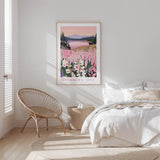 a serene bedroom scene with a large framed poster of a field of flowers hanging on the wall, a woven chair, and a bed with white bedding.