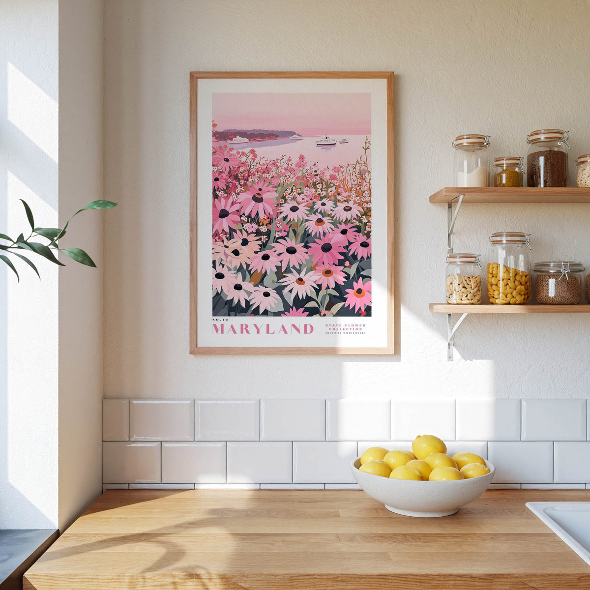 a framed poster of a field of flowers, a wooden counter with a bowl of lemons, and shelves displaying various jars and containers.