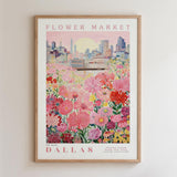 The image is a framed poster depicting a cityscape with a field of colorful flowers in the foreground.