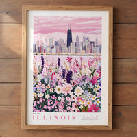 A framed poster depicting a cityscape with a field of colorful flowers in the foreground, representing the state flower of Illinois.