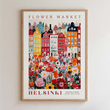 The image is a framed poster depicting a colorful and vibrant cityscape with a variety of flowers and buildings.