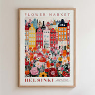 The image is a framed poster depicting a colorful and vibrant cityscape with a variety of flowers and buildings.