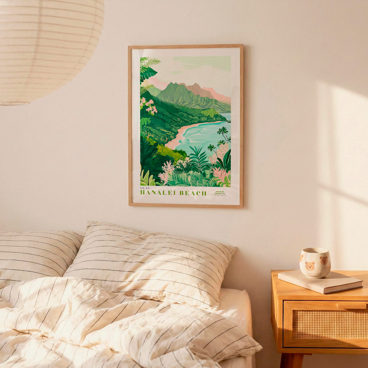 a bedroom with a framed poster of a tropical beach landscape hanging on the wall above a bed with striped pillows.