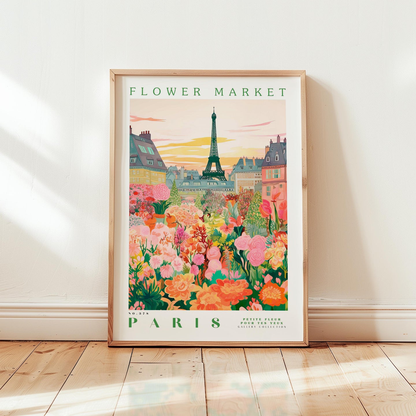 A framed poster depicting a colorful and vibrant flower market in Paris, with the Eiffel Tower in the background.