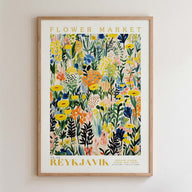 The image is a framed poster or print featuring a vibrant, colorful floral pattern with various types of flowers and foliage.