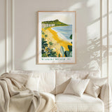 a framed poster of a beach scene with palm trees and a mountain in the background, hanging on a wall above a white couch with a blanket draped over it.