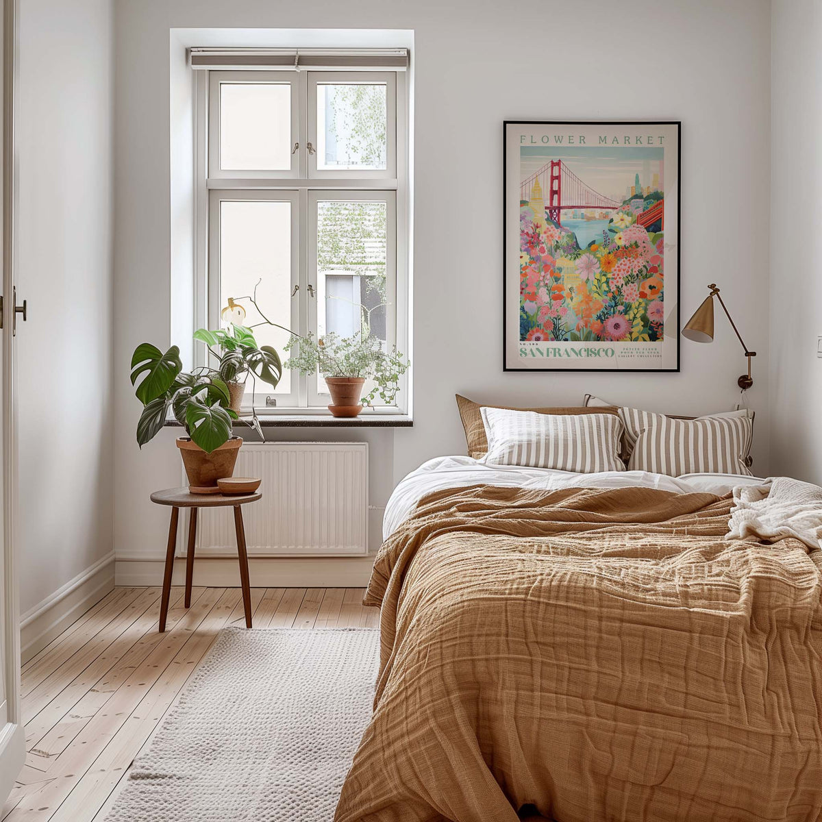 A cozy bedroom with a large bed, a nightstand with a plant, and a framed poster of the Golden Gate Bridge on the wall.