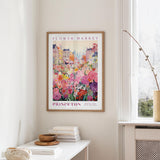 a framed poster of a colorful flower market in Princeton, New Jersey, hanging on a wall.