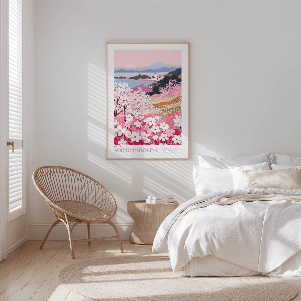 A bedroom with a large bed, a woven chair, and a framed poster of a floral landscape hanging on the wall.