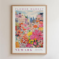 The image is a framed poster depicting a vibrant and colorful flower market in Newark, with a variety of flowers and buildings in the background.