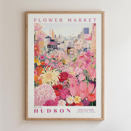 A framed poster depicting a vibrant and colorful flower market in Hudson, New York.