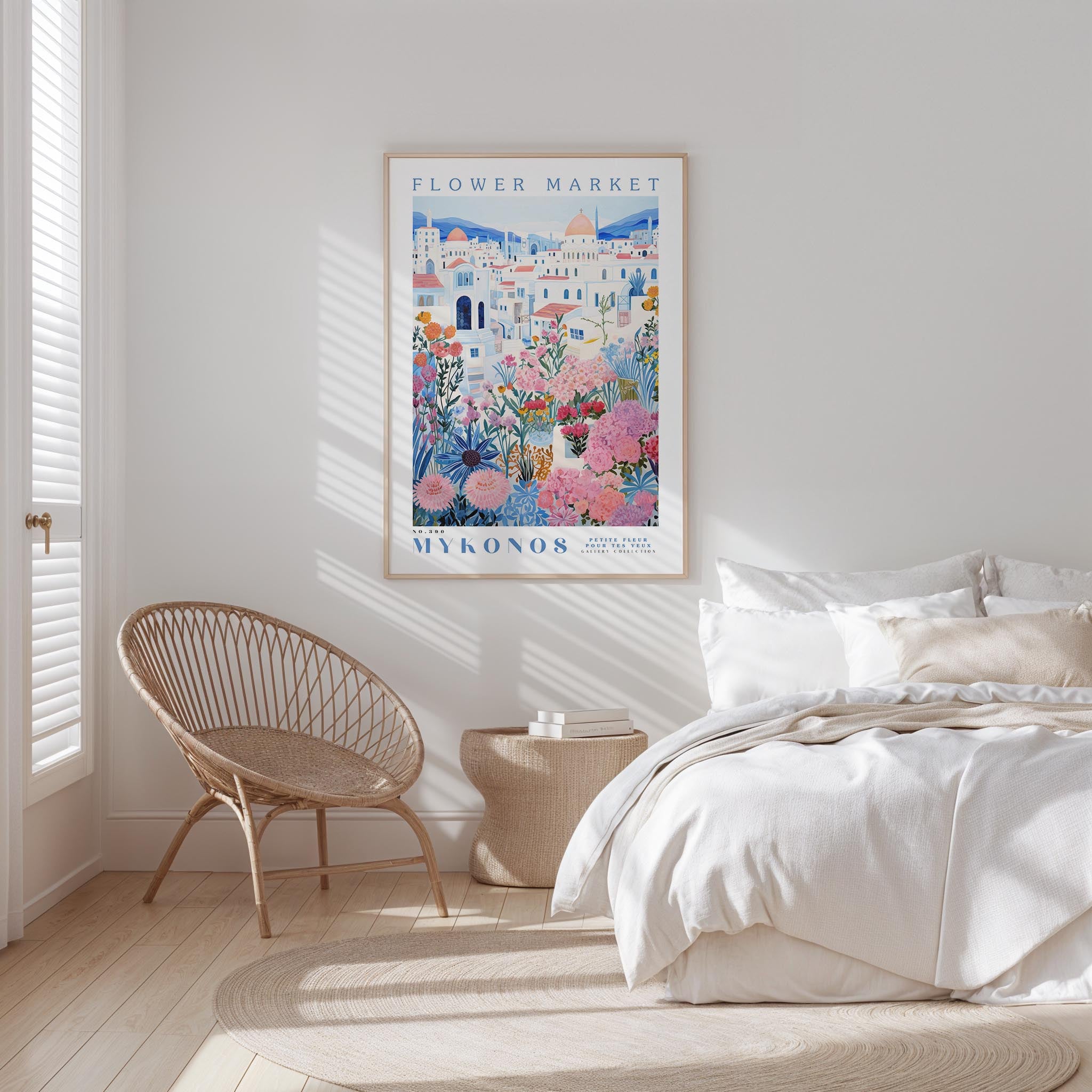 a bedroom with a bed, a woven chair, and a framed poster of a flower market on the wall.