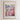 The image is a framed poster depicting a cityscape with a large field of colorful flowers in the foreground.