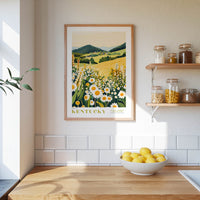a kitchen scene with a framed print of a field of flowers hanging on the wall, a wooden counter with a bowl of lemons, and shelves displaying various jars and containers.
