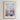 The image is a framed poster depicting a colorful and vibrant flower market in Santorini, Greece.
