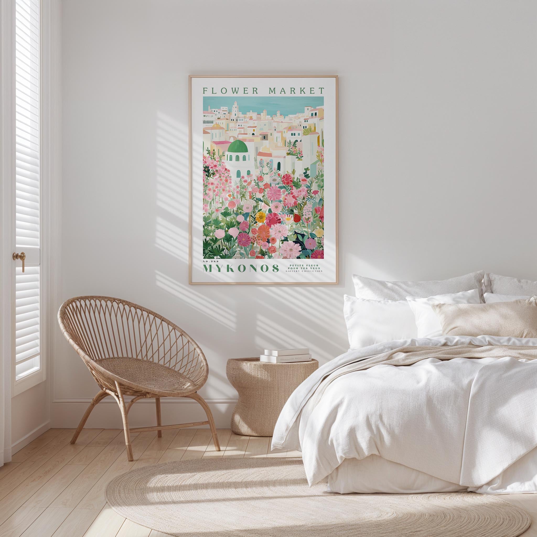 a bedroom with a bed, a woven chair, and a framed poster of a flower market in the background.