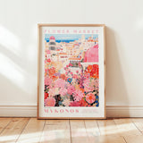 A framed poster depicting a vibrant and colorful flower market in Mykonos, Greece.
