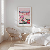 a bedroom with a large framed poster of a city skyline hanging on the wall above a bed with white bedding.
