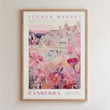 The image is a framed poster depicting a cityscape with a flower market in the background.