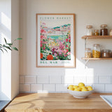 a framed poster of a flower market, a wooden counter with a bowl of lemons, and shelves with jars and containers.